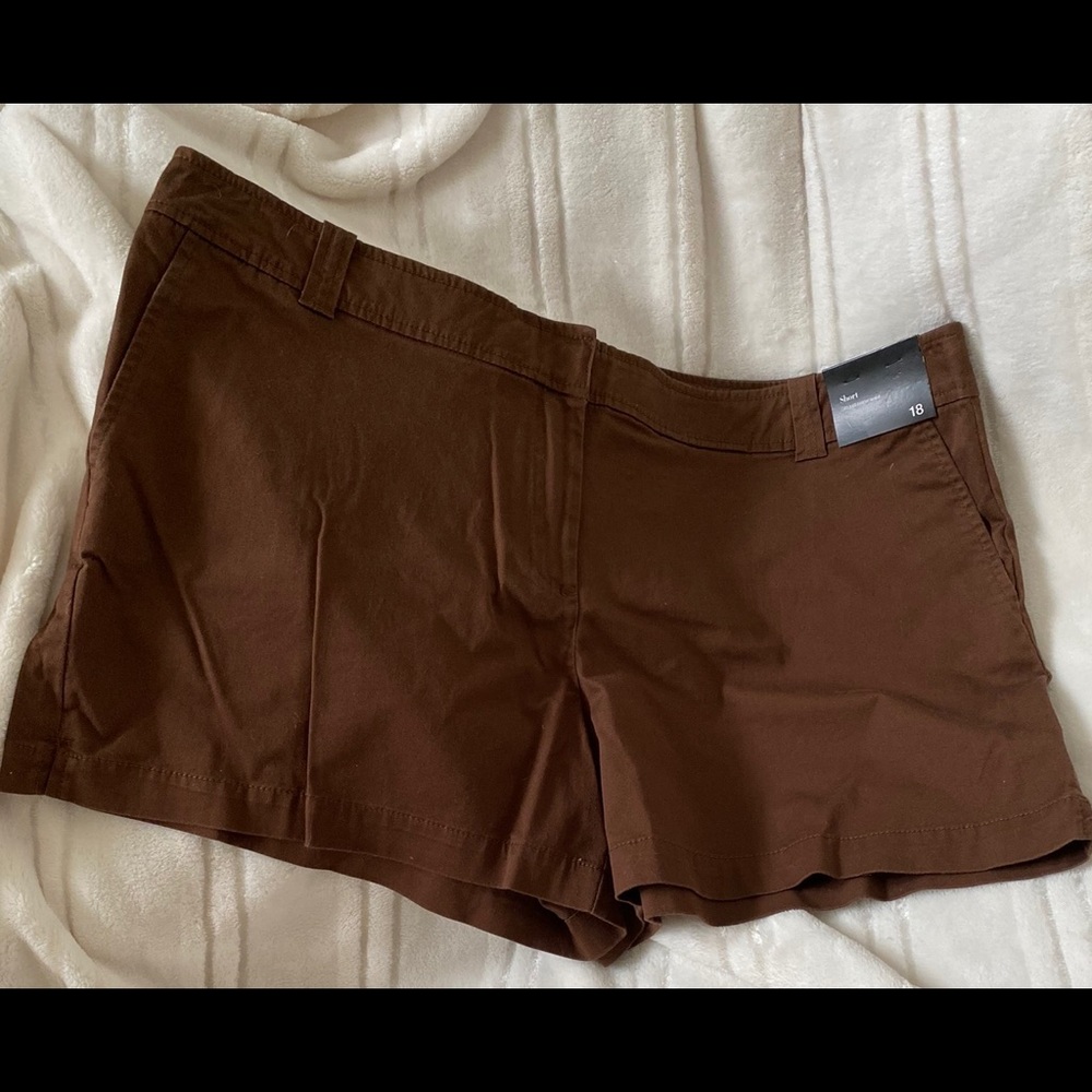 Brown shorts that sit just below the waist